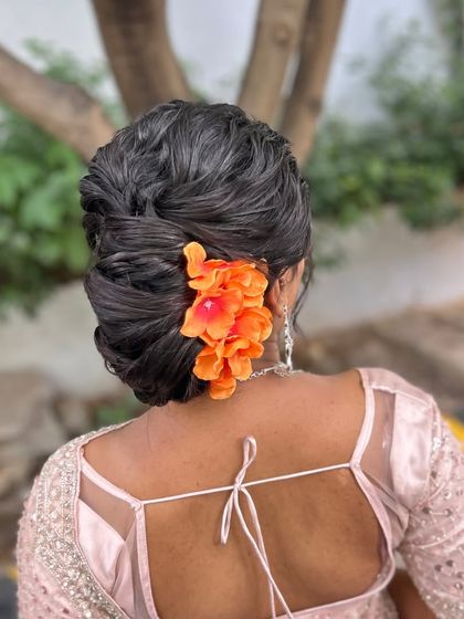 A clear shot of the textured bun with the vibrant orange flowers, adding a pop of color.