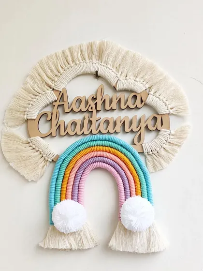 I love making these personalized rainbow name hangings for kids' rooms. This one for Aashna and Chaitanya uses soft pastel threads and fluffy pom-pom clouds to create a cheerful and dreamy piece of wall decor. We can customize the name and colors to perfectly match your little one's space.