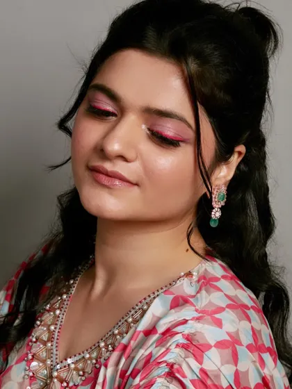 A beautiful example of creative makeup from a student's portfolio. The pop of pink eyeliner is fun, fresh, and editorial.