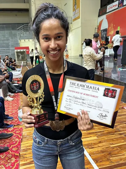 We don't just train, we build champions. Here is our golden girl, Priyanka, proudly showing off her trophy and certificate from a powerlifting competition. Her success is a testament to her hard work and the expert coaching she receives at Absolute Fit.