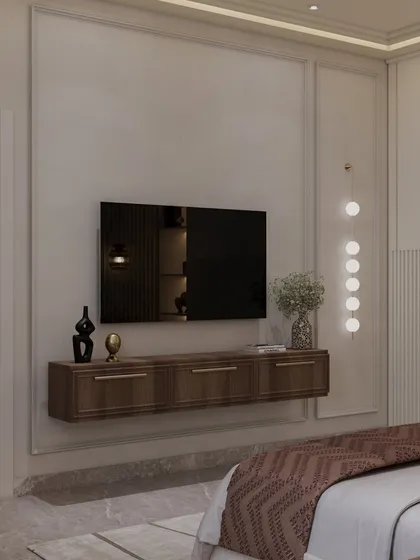 The TV is mounted on a clean, minimalist wall with a floating wooden console below. A single, elegant pendant light adds a sculptural element to the corner.