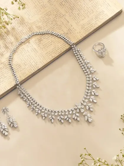 An elegant and delicate shot of a diamond necklace set. We used a vintage-style paper background and sprigs of baby's breath to create a soft, romantic, and timeless feel for this fine jewellery piece.