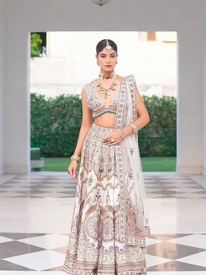 A classic portrait in a grand hallway. The ivory lehenga with its colorful embroidery is a true work of art that I had the pleasure of styling.