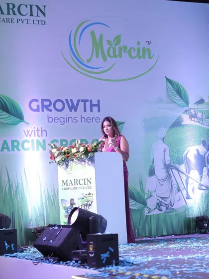 On stage for Marcin Crop Care, where "Growth begins here." I adapt my hosting to fit any industry, including agriculture.