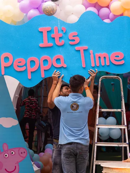 It's Peppa Time! The final touches are put on the backdrop, a team effort to bring the magical setup to life.