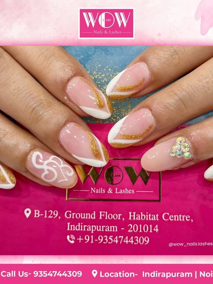 A sophisticated design featuring a sheer nude base with white and gold glitter accents. The addition of small rhinestones at the cuticle adds a final touch of elegance.