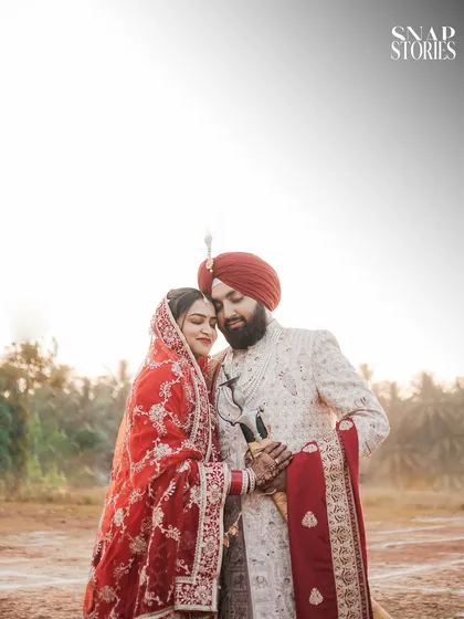 A beautifully lit portrait of the couple against the sky. We use natural light to create soft, romantic, and ethereal wedding photographs.