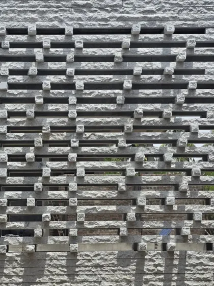 The 'Tiruppur house' jaali wall in its entirety. It is a symphony in stone, a porous skin that allows the building to breathe.