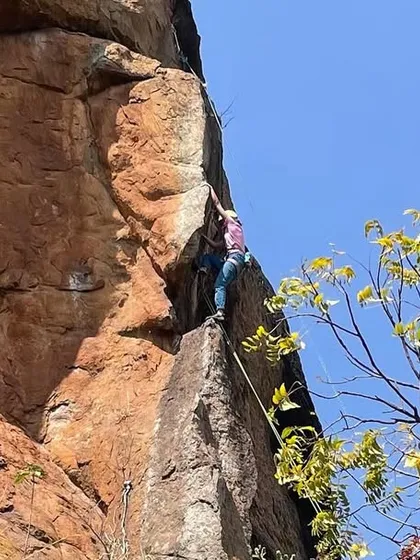 A climber on a beautiful, exposed arête at Talai Betta. The climbing here is as aesthetic as it is challenging.