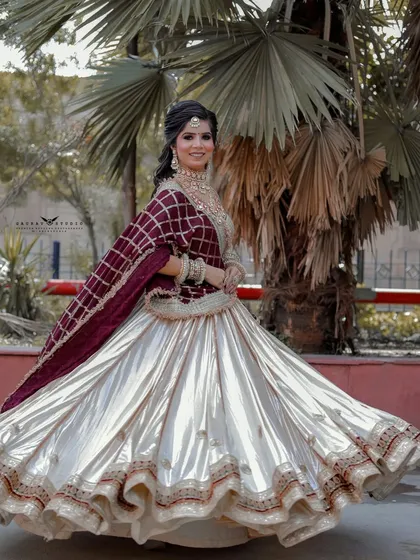 Capturing the beautiful movement and flare of a lehenga is key to a great bridal shoot. This outdoor shot uses natural light to create a joyful and energetic portrait that feels alive.