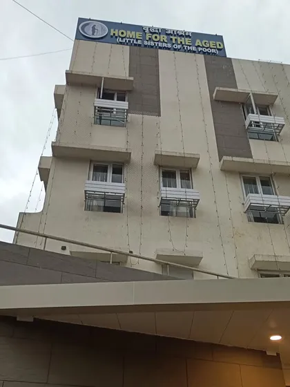 The facade of the Home for the Aged building. The design incorporates shaded windows and a clean, modern aesthetic to create a pleasant and functional environment for its residents.