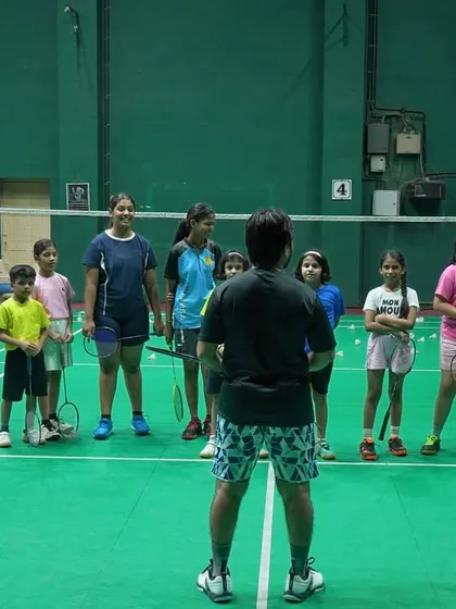 A coach addressing our junior batch. We believe in clear communication and setting expectations right from the start of the training session.