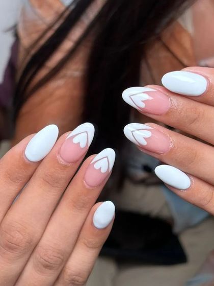 A different angle of the white and negative space heart design. It's a chic and minimalist way to do heart-themed nails.