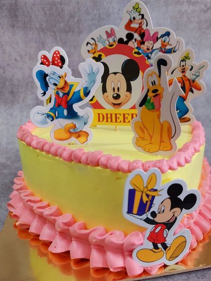 This cheerful cake brings the whole gang together with a Mickey Mouse and friends theme. It features Mickey, Minnie, Donald, Goofy, and Pluto, making it a classic and joyful choice for a kid's birthday.