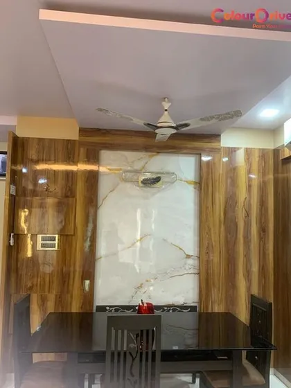A full view of the dining space from a recent project. Our work here included the false ceiling installation, wall paneling, and ensuring a flawless finish across all surfaces for a complete and polished look.