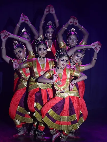 A beautiful group formation from 'Narasimha Kavuthuvam', where the dancers create a visually complex and meaningful shape on stage.
