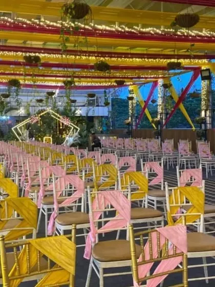 Guest seating on the Sky Terrace, with alternating pink and yellow chair sashes adding a pop of color to the celebration.