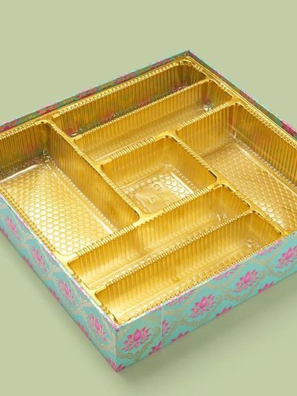 An empty festive gift box with compartments, shot for a packaging company's catalogue. We photograph packaging to show its structure and potential use.