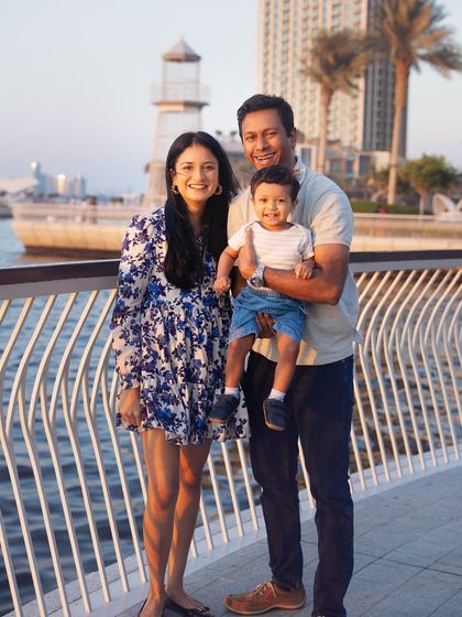 A lovely family portrait by the water in Dubai. The cityscape and natural surroundings provide a stunning backdrop for your family memories.