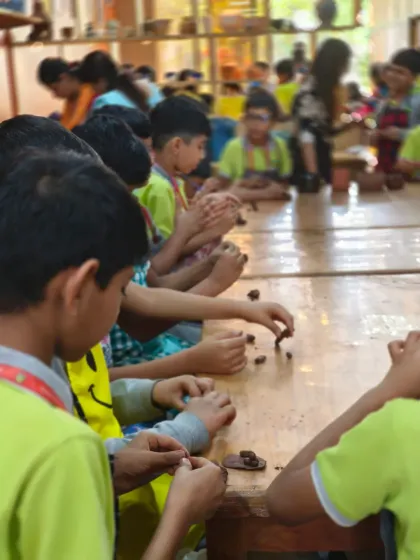 Young students deeply focused on their creations. We provide a nurturing environment where children can explore their creativity and learn the basics of hand-building with clay.