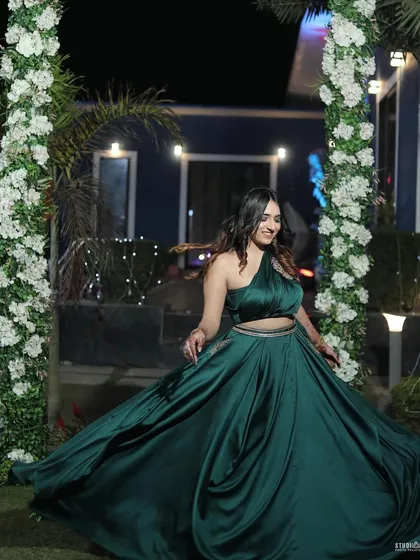 A happy, twirling motion shot in the green gown. This conveys a sense of freedom and celebration, perfect for event wear.