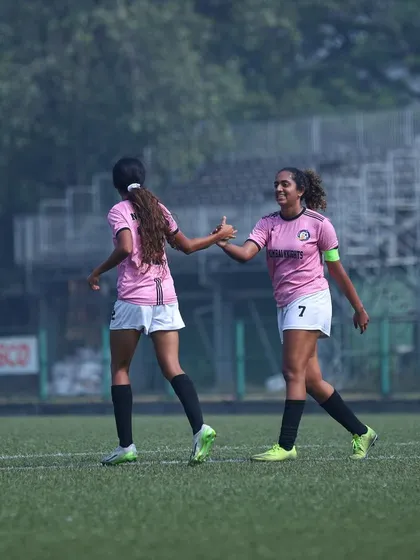 Teammates congratulating each other after a goal, highlighting our team spirit.