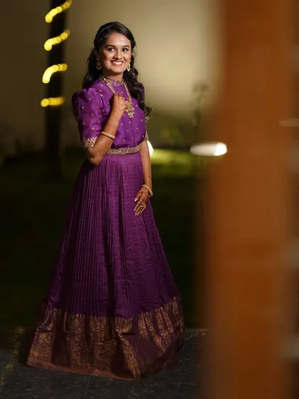 A full-length view of the client in her purple gown, showcasing its regal silhouette.