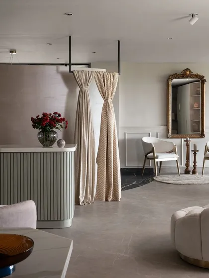 Every corner of our Experience Center is a testament to thoughtful design. Here, modern chairs and soft drapes complement a classic gilded mirror, demonstrating how we blend different styles into a harmonious whole.