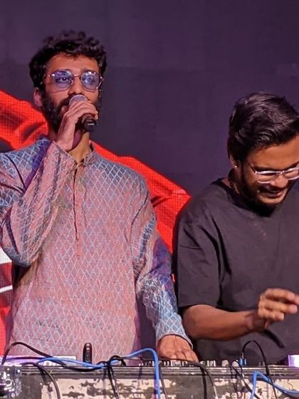 On the mic with my partner DJ, ensuring the energy stays high throughout the corporate event.