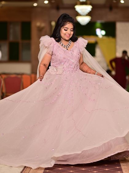 A full, twirling shot of this beautiful pink engagement gown. The layers of tulle and delicate ruffles create a dreamy, romantic effect.