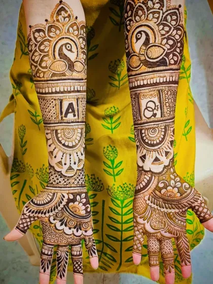 A majestic engagement design featuring peacock motifs and the couple's initials, "A" and "&", framed beautifully on each arm.