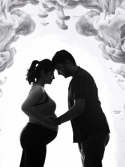 An intimate black and white silhouette of a couple, framed by a beautiful smoke arch. This artistic effect adds a touch of mystery and romance to the portrait.