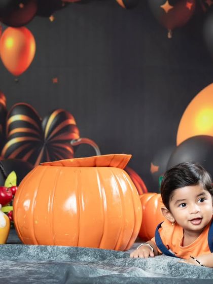 This little one is enjoying tummy time during the Halloween shoot.