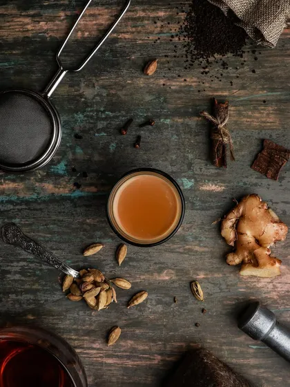 A flatlay or top-down shot of masala chai ingredients. This type of image is great for showcasing the natural, aromatic elements that go into a product.