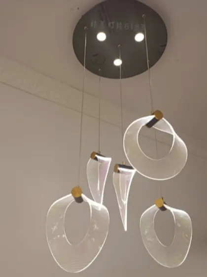 An abstract cluster of acrylic pendants, creating a floating, ethereal effect. This is a great choice for a modern entryway or stairwell.