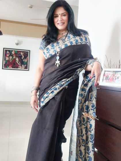 A full-length view of the cotton silk saree at home. The block print design gives it a classic yet contemporary feel, making it suitable for a relaxed family get-together.
