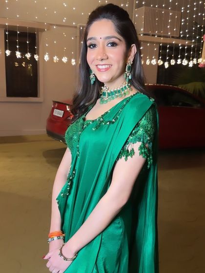 A stunning look for a Sufi Night. The emerald green saree is complemented by soft, glowing makeup and a subtle smokey eye for an evening of elegance.