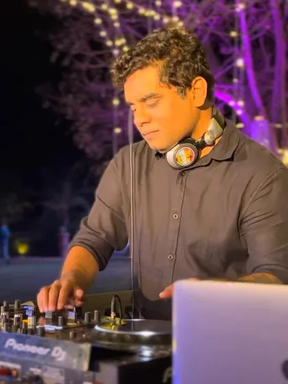 In the zone at an outdoor wedding event. The beautiful lighting and decor create a magical setting, and I make sure the music matches that enchanting atmosphere.