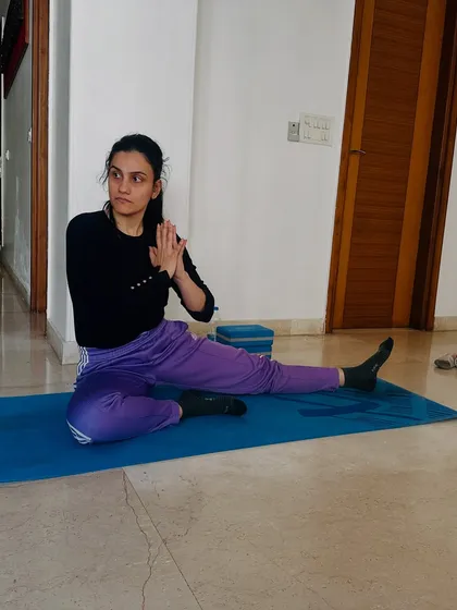 A student holds a challenging twist in our advanced workshop. These sessions are designed to push your limits in a supportive and educational environment.