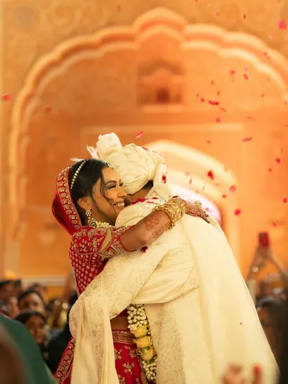 A moment of pure emotion as Vedika and Shubhang share a heartfelt hug after their ceremony, with rose petals falling around them. This is the candid, story-driven photography I love to capture.