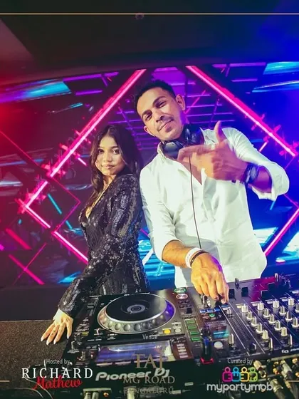 A picture with my co-DJ against a backdrop of dazzling geometric lights. The visual aspect of the show was stunning.