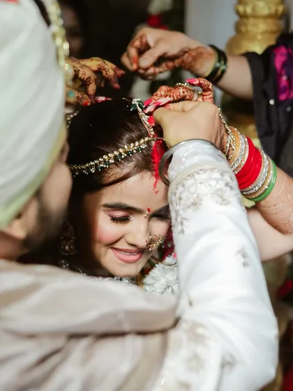 The tying of the mangalsutra is a key moment we always capture with care. This close-up shot shows the bride's happy expression as the ritual is performed.
