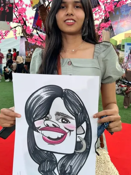 An anime fan with her caricature. The outdoor festival setting was fantastic.