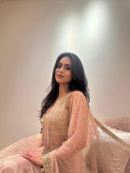 Nysa Devgan in a delicate blush pink and gold lehenga, a soft and romantic look for a wedding celebration.