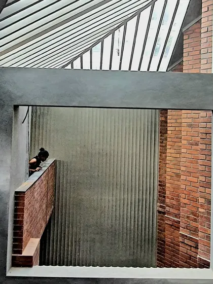 This image from the Brick House captures the essence of our design philosophy: creating layered spaces where light, material, and human presence come together to form a cohesive narrative.
