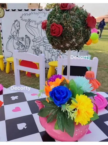 The kids' activity table, featuring a large Alice in Wonderland coloring canvas.