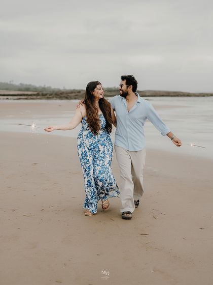 Walking along the sand with sparklers in hand, their smiles lighting up the evening. A perfect blend of fun and romance for a pre-wedding shoot.
