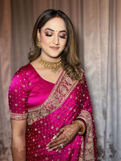 A close-up of the reception makeup, showing the soft gold and pink tones on the eyes.