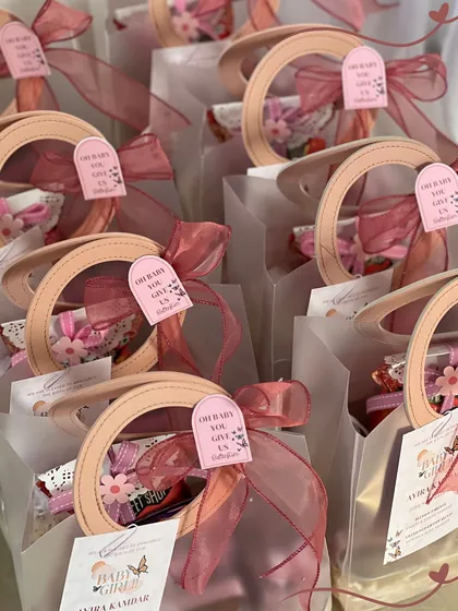 The finished announcement bags, all lined up and ready to go. The pink ribbons and custom tags bring the whole look together.