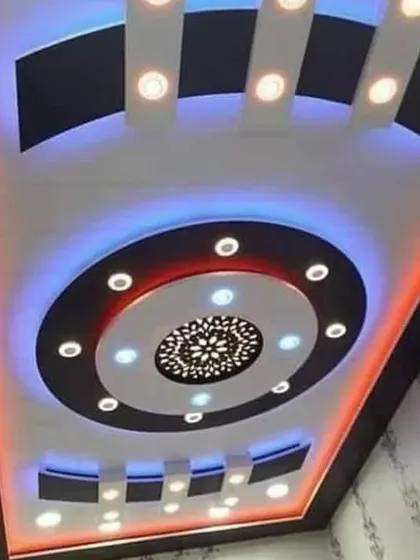 A modern circular design that uses a combination of red and blue lighting for a high-contrast, futuristic look. The central jali cutout adds a decorative touch.